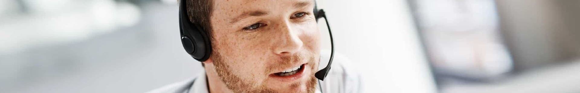 Opérateur de hotline technique analysant un incident client au téléphone